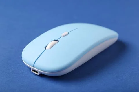 Modern wireless blue computer mouse on color background, closeup Stock Photos