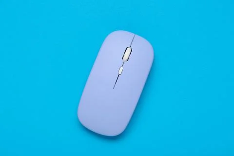 Modern wireless blue computer mouse on color background Stock Photos