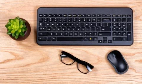 Modern wireless computer keyboard on new red oak desktop Stock Photos