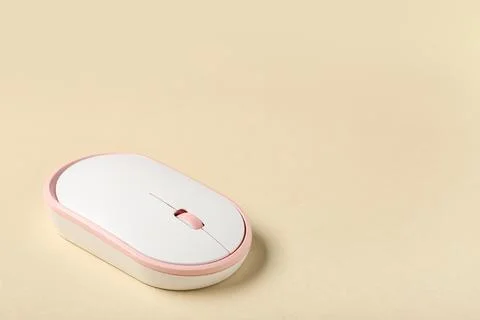 Modern wireless computer mouse on beige background Stock Photos