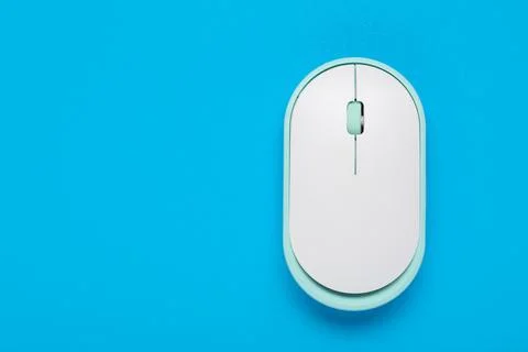 Modern wireless computer mouse on blue background Stock Photos