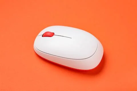 Modern wireless computer mouse on orange background Stock Photos