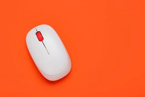 Modern wireless computer mouse on orange background Stock Photos