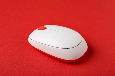 Modern wireless computer mouse on red background Stock Photos