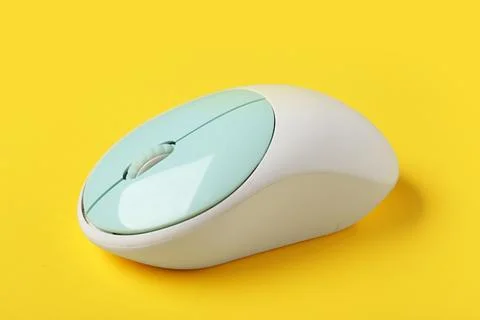 Modern wireless computer mouse on yellow background Stock Photos