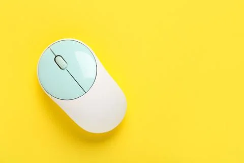 Modern wireless computer mouse on yellow background Stock Photos