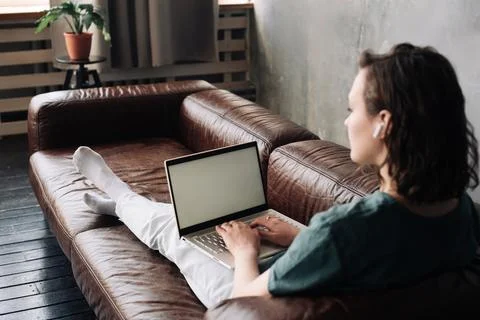 Modern Work and Connectivity: Young Woman Utilizing Laptop with Blank Scree.. Stock Photos