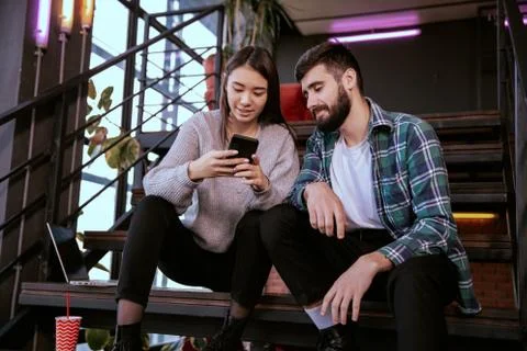 On the modern work office studio one good looking guy and pretty lady smiling Stock Photos