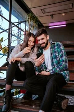 On the modern work office studio one good looking guy and pretty lady smiling Foto stock