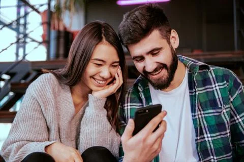 On the modern work office studio one good looking guy and pretty lady smiling Stock Photos