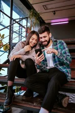 On the modern work office studio one good looking guy and pretty lady smiling Stock Photos