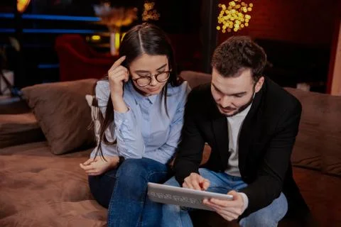 On the modern work office studio one good looking guy and pretty lady smiling Stock Photos