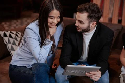 On the modern work office studio one good looking guy and pretty lady smiling Stock Photos