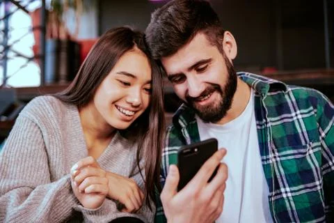 On the modern work office studio one good looking guy and pretty lady smiling Stock Photos