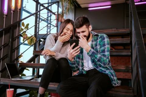 On the modern work office studio one good looking guy and pretty lady smiling Stock Photos