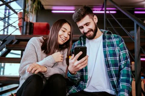 On the modern work office studio one good looking guy and pretty lady smiling Stock Photos