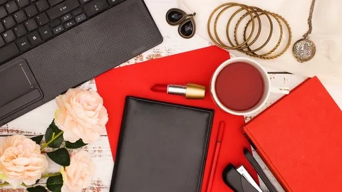 Modern work space and office desk with female accessories in red-Stop motion Stock Footage 123138552