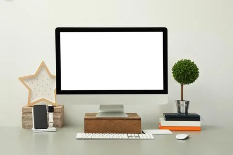 Modern workplace with computer, charging devices and decor elements. Interior 库存照片