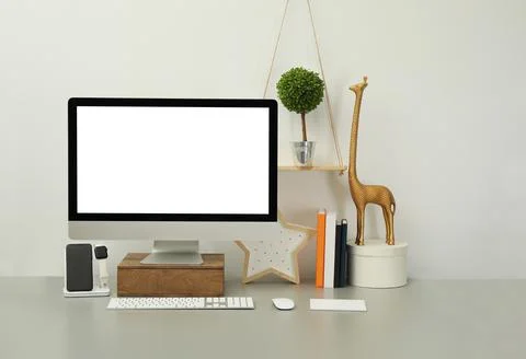 Modern workplace with computer, charging devices and decor elements. Interior Stock Photos