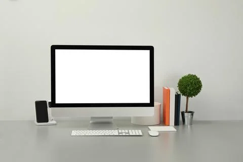 Modern workplace with computer, charging devices and decor elements. Interior Stock Photos