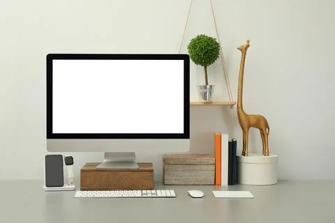 Modern workplace with computer, charging devices and decor elements. Interior Stock Photos
