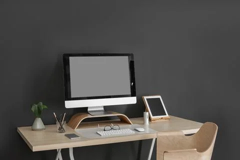 Modern workplace interior with computer and devices on table. Space for text Stock-Fotos