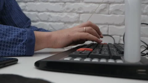 Modern workplace. Night work. A man is sitting at a computer in a dressing gown Stock Footage 131669673