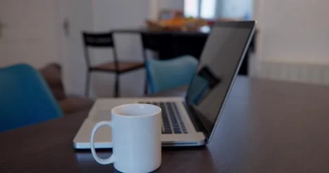 A modern workspace is captured, featuring a sleek laptop and a mug. Stock Footage 334651260
