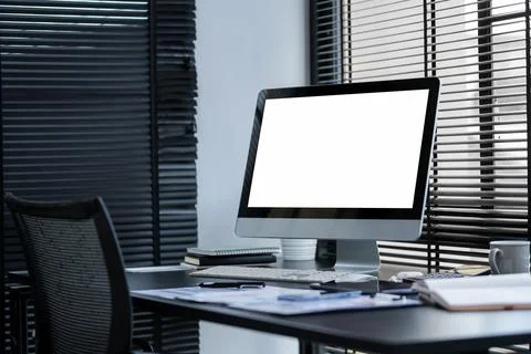Modern workspace with computer with blank screen and equipment on white tab.. Stock Photos