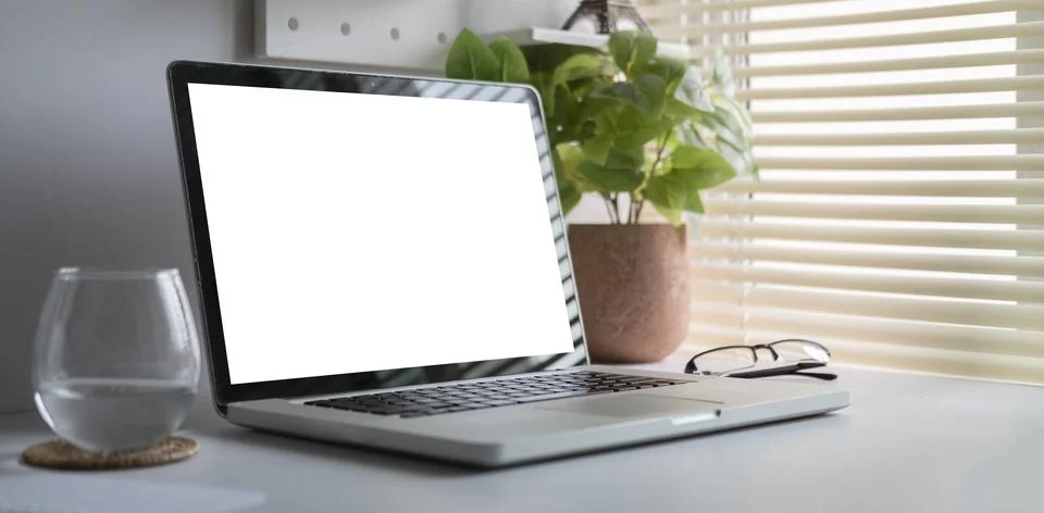 Modern workspace with computer with blank screen and equipment on white tab.. Stock Photos