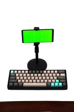 Modern workspace featuring a mechanical keyboard and smartphone with chroma.. Stock Photos