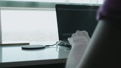Modern Workspace with Laptop and Wireless Charger Stock Footage 314994376