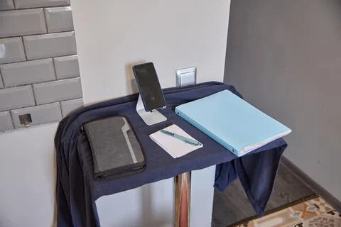 Modern workspace setup with smartphone, notebook, pen, and tablet on blue c.. Stock Photos