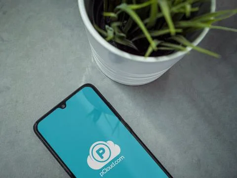 Modern workspace with smartphone with pCloud app launch screen on marble ba.. Stock Photos