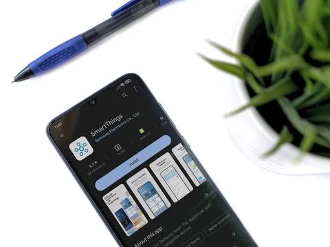 Modern workspace with smartphone with Smartthings app play store page on wh.. Stock Photos