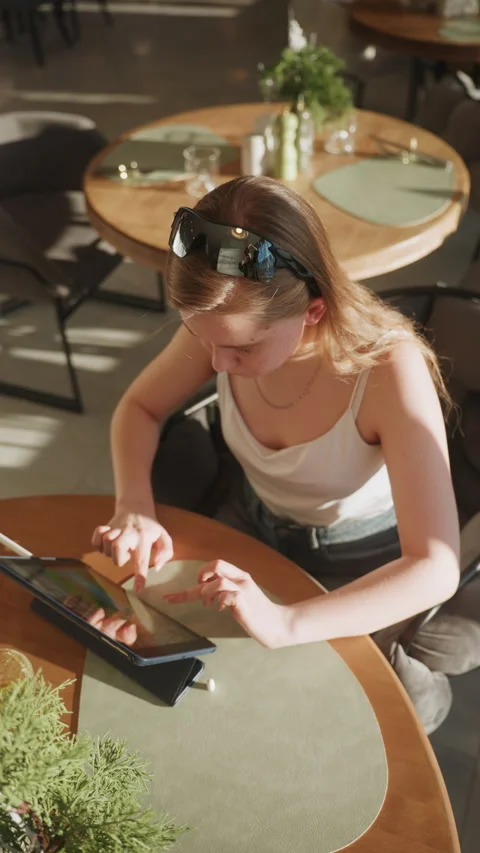 Modern workspace with stylus and bright lighting. Contemporary cafe setting with Stock Footage 333474853