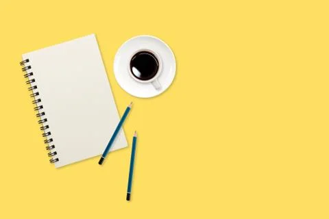Modern workspace table top view with notebook on yellow background Stock Photos
