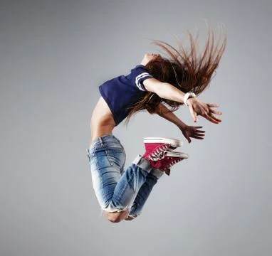 Modern young beautiful dancer posing on a studio background Stock Photos