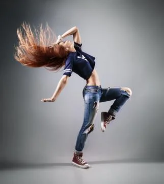 Modern young beautiful dancer posing on a studio background Stock Photos