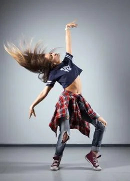 Modern young beautiful dancer posing on a studio background Stock Photos
