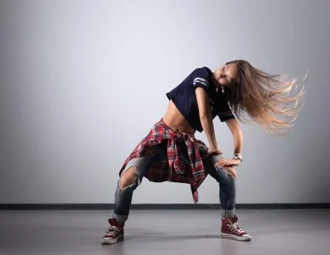 Modern young beautiful dancer posing on a studio background Stock Photos