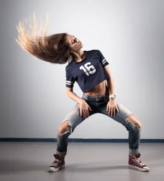 Modern young beautiful dancer posing on a studio background Stock Photos