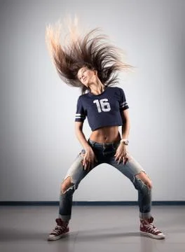 Modern young beautiful dancer posing on a studio background Stock Photos