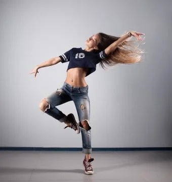 Modern young beautiful dancer posing on a studio background Stock Photos
