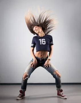 Modern young beautiful dancer posing on a studio background Stock Photos