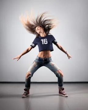 Modern young beautiful dancer posing on a studio background Stock Photos