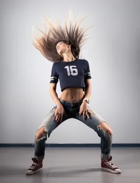 Modern young beautiful dancer posing on a studio background Stock Photos