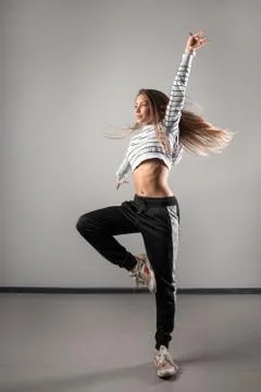 Modern young beautiful dancer posing on a studio background Stock Photos