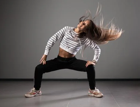 Modern young beautiful dancer posing on a studio background Stock Photos