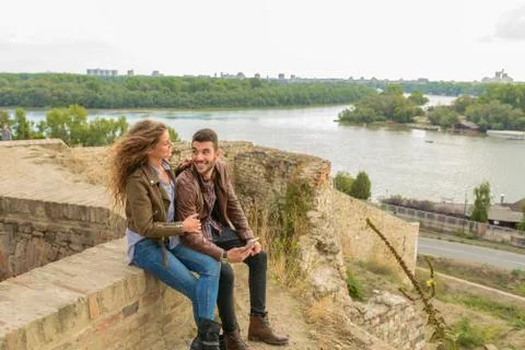 Modern young couple using their mobile phone near the river Foto stock